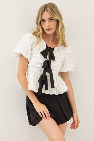 BUBBLE BABYDOLL BLOUSE WITH TEXTURED FABRIC AND CONTRAST BOW